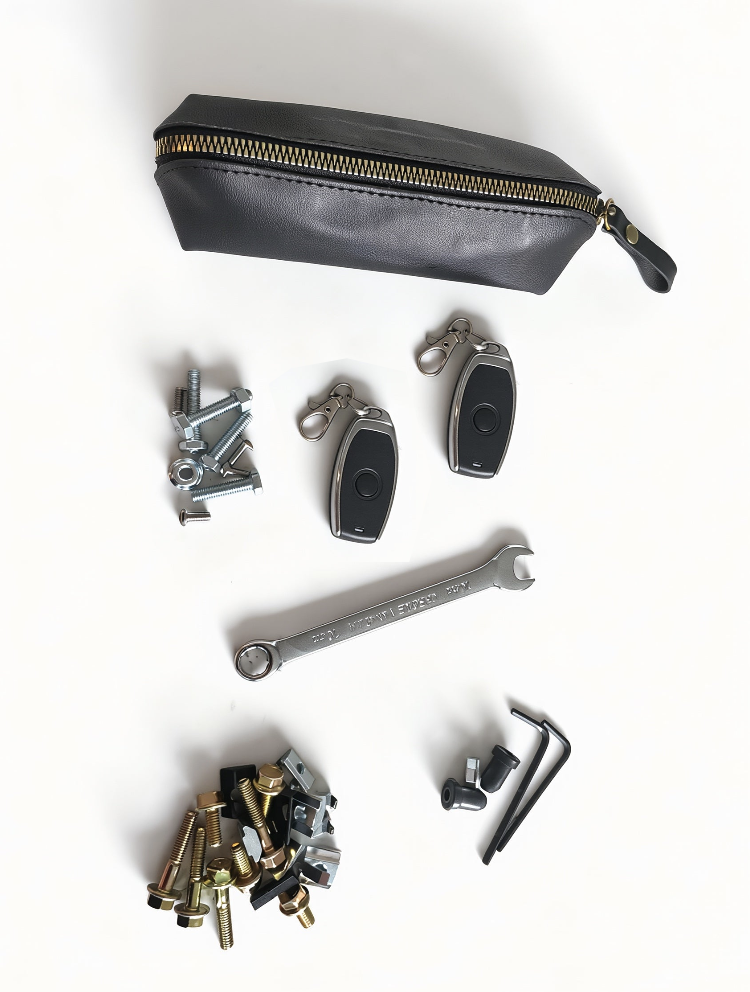 Collection of tools and car keys on a white background with a black pouch.